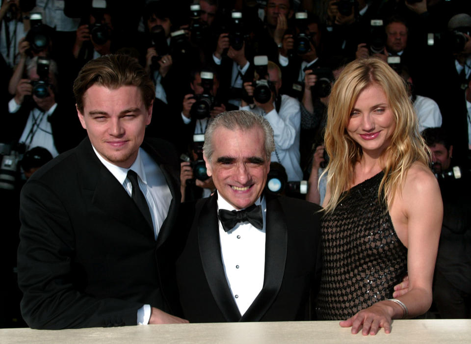 American director Martin Scorsese (C) poses in front of a wall of photographers with American actress Cameron Diaz (R) and American Actor Leonardo DiCaprio (L) during a photocall for the official screening of his film 