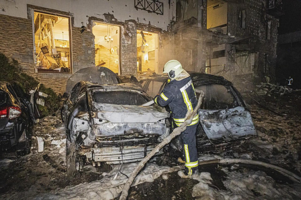 In this photo provided by the Ukrainian Emergency Service, firefighters work to extinguish a fire after a Russia's missile attack that hit a hotel in Kharkiv, Ukraine, late Wednesday, Jan. 10, 2024. (Ukrainian Emergency Service via AP)