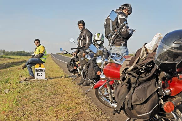 Indian motorcyclists stopped on side of road.