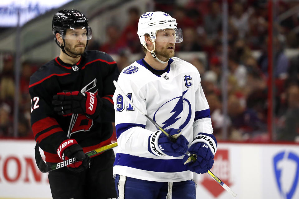 Carolina Hurricanes' Brett Pesce (22) and Tampa Bay Lightning's Steven Stamkos (91) 