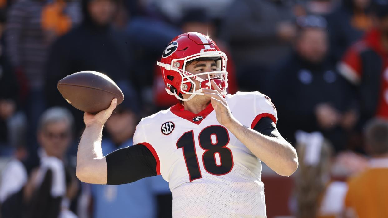 Georgia quarterback JT Daniels (18) throws during warmups in an NCAA football game on Saturday, Nov. 13, 2021, in Knoxville, Tenn. (AP Photo/Wade Payne)