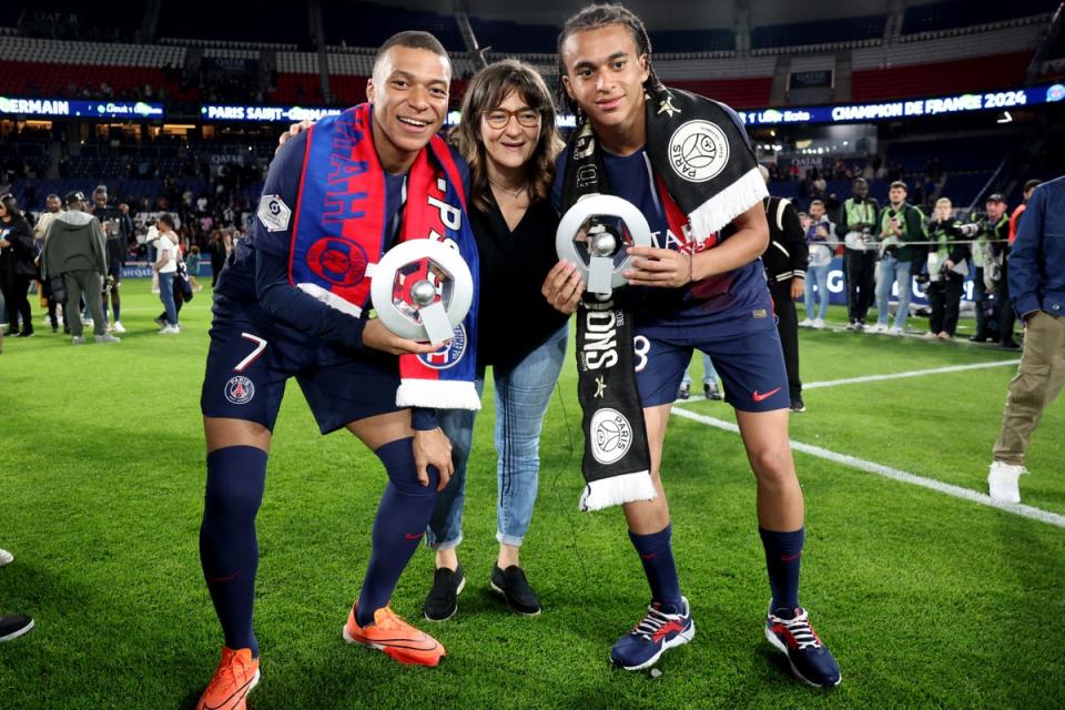Mbappe and his brother and teammate Ethan pose with their mother after winning the Ligue 1 title this season (POOL/AFP via Getty Images)