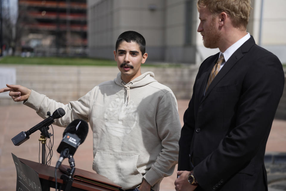 Kevin Mehr, attorney representing Kenneth Espinoza, right, and Kenneth's son Nathaniel, speak at a news conference, Tuesday, May 2, 2023, outside the federal courthouse in Denver. Kenneth Espinoza says he was repeatedly stunned with a Taser while handcuffed, including once in the face, and is suing a Colorado sheriff’s department. The suit filed this week alleges excessive force by two deputies from the Las Animas County Sheriff's Office. (AP Photo/David Zalubowski)