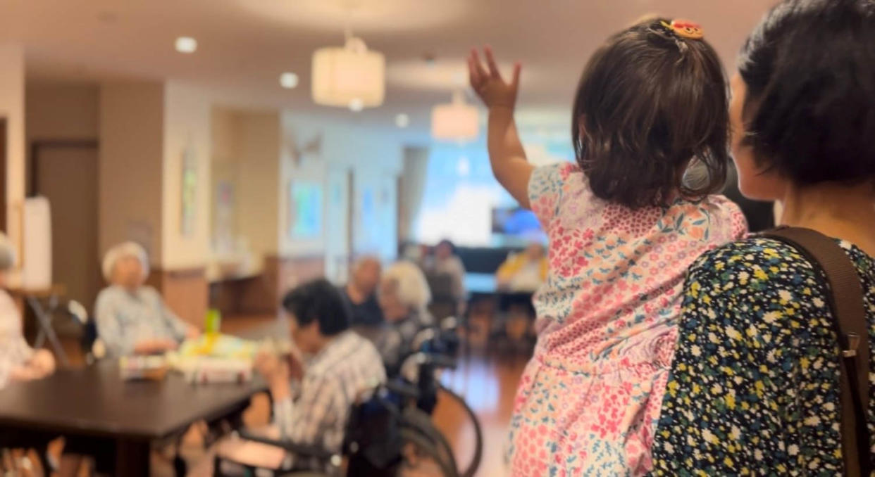 Rena waves goodbye at the end of a visit to the nursing home.  (Janis Frayer / NBC News)