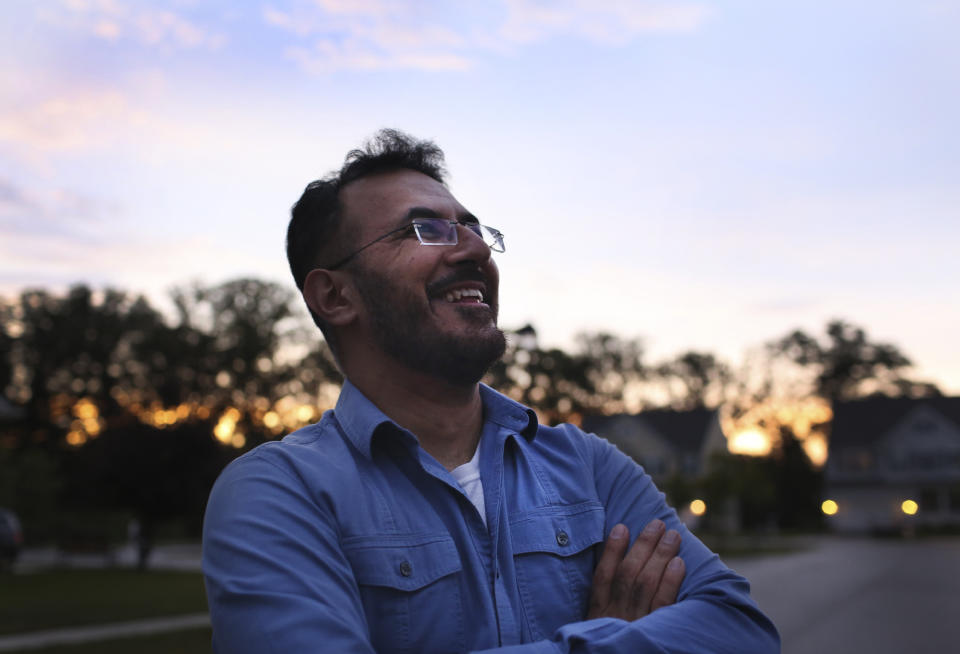 Mansoor Shams, a former US Marine, stands at the end of his driveway on Friday evening, Aug. 13, 2021 in Baltimore. Shams, who served in the Marines from 2000 to 2004, was called names like "Taliban," "terrorist" and "Osama bin Laden" by some of his fellow Marines after 9/11. In recent years, Shams has used his identity as both a Muslim and a former Marine to dispel misconceptions about Islam. (AP Photo/Jessie Wardarski)