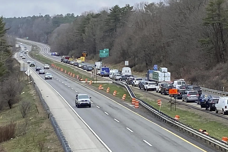 In a still frame from video provided by WGME-TV traffic is backed up near a scene where people were injured in a shooting on Interstate 295, in Yarmouth, Maine, Tuesday, April 18, 2023. Gunfire that erupted on the busy highway is linked to a second crime scene where several people have been found dead in a home about 25 miles away in the town of Bowdoin, Maine, state police said Tuesday. (WGME-TV via AP)