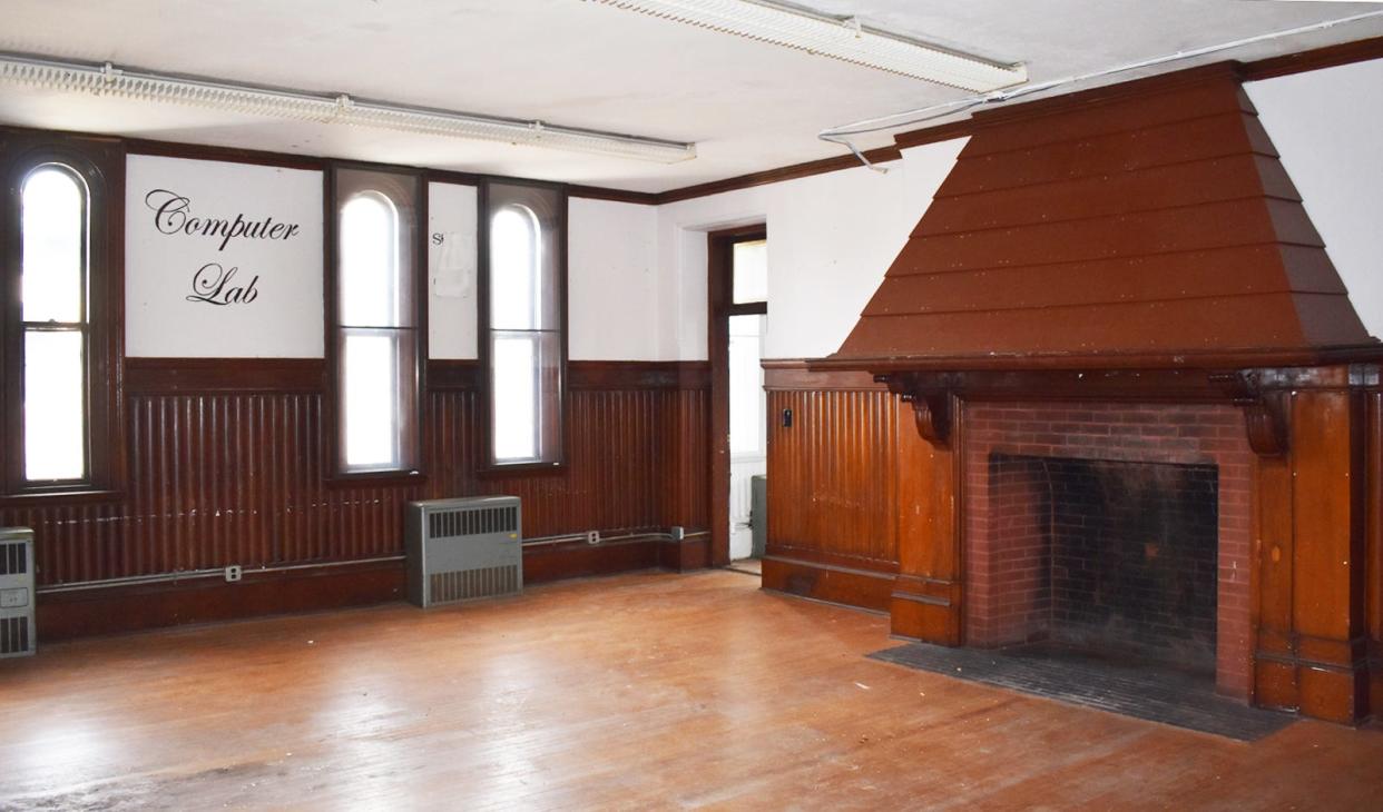A room that was once the computer lab and library inside the Bank Street Armory, on Bank Street in Fall River, is dominated by a large fireplace.