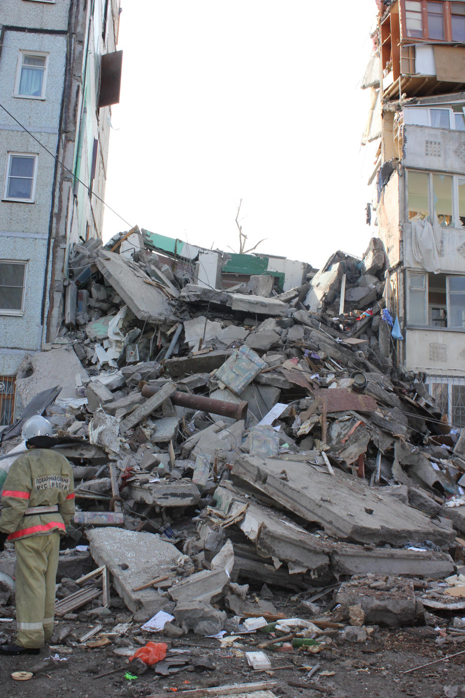 In this photo distributed by Astrakhan branch of the Ministry for Emergency Situations, Emergency Situations Ministry rescuer inspects debris of an apartment building after it exploded on Monday morning, Feb. 27, 2012, in Astrakhan, Russia. Such gas explosions are frequent in Russia.(AP Photo/ Astrakhan Branch, Ministry of Emergency Situations Press Service,)