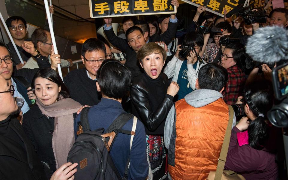 Civic Party lawmaker Tanya Chan attends a protest in Hong Kong on March 27, 2017. Police cracked down on Hong Kong democracy activists saying they would be charged over the Umbrella Movement mass protests, a day after a pro-Beijing candidate was chosen as the city's new leader.  - Credit: Jayne Russell/AFP