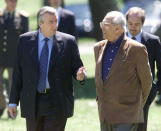 Former Uruguayan President Jorge Batlle (R) and former Argentine President Nestor Kirchner chat as they walk by the Uruguayan presidential ranch in Colonia, Uruguay, in this October 9, 2003 file picture. Batlle, who was Uruguayan President from 2000 to 2005, died on October 24, 2016 according to local media. REUTERS/Andres Stapff/File Photo