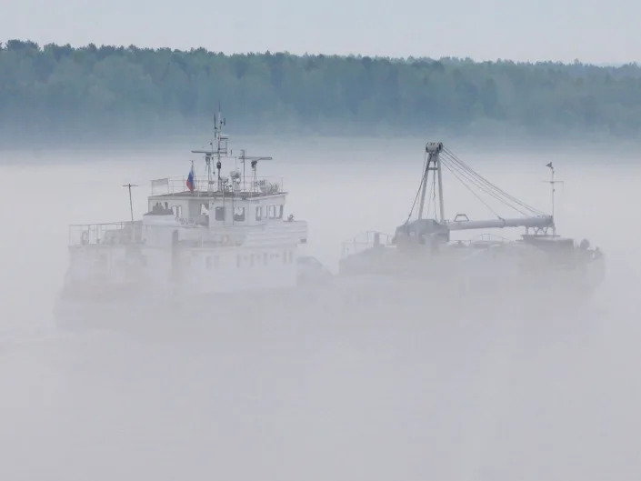 A ship sails through the morning fog along the Yenisei River near Galanino village, about 250 km north of Russia's Siberian city of Krasnoyarsk, June 13, 2013.