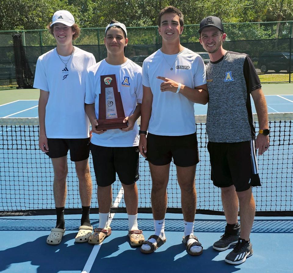 From left, Auburndale's Kyle Fox, Angel Guilarte, Chad Williams and head coach Logan Allen pose with the team trophy after winning the Class 3A, District 6 boys tennis tournament.