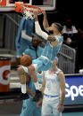 Charlotte Hornets forward Caleb Martin, center, throws down a two-handed dunk against the Los Angeles Lakers during the first half of an NBA basketball game in Charlotte, N.C., Tuesday, April 13, 2021. (Jeff Siner/The Charlotte Observer via AP)