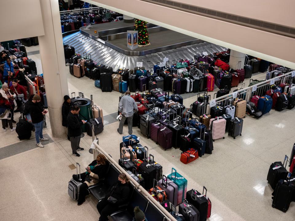 Stranded travelers search for their luggage at the Southwest Airlines Baggage Claim at Midway Airport on December 27, 2022 in Chicago, Illinois.