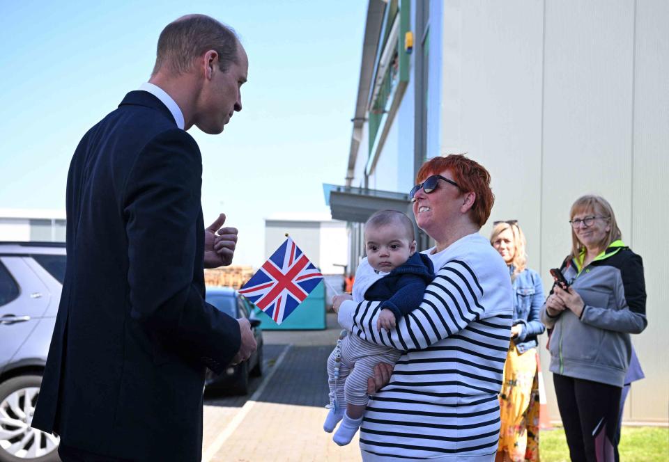 <p>OLI SCARFF/POOL/AFP via Getty</p> Prince William (left) meets Andrea Newton and her grandson after visiting Low Carbon Materials on April 30, 2024