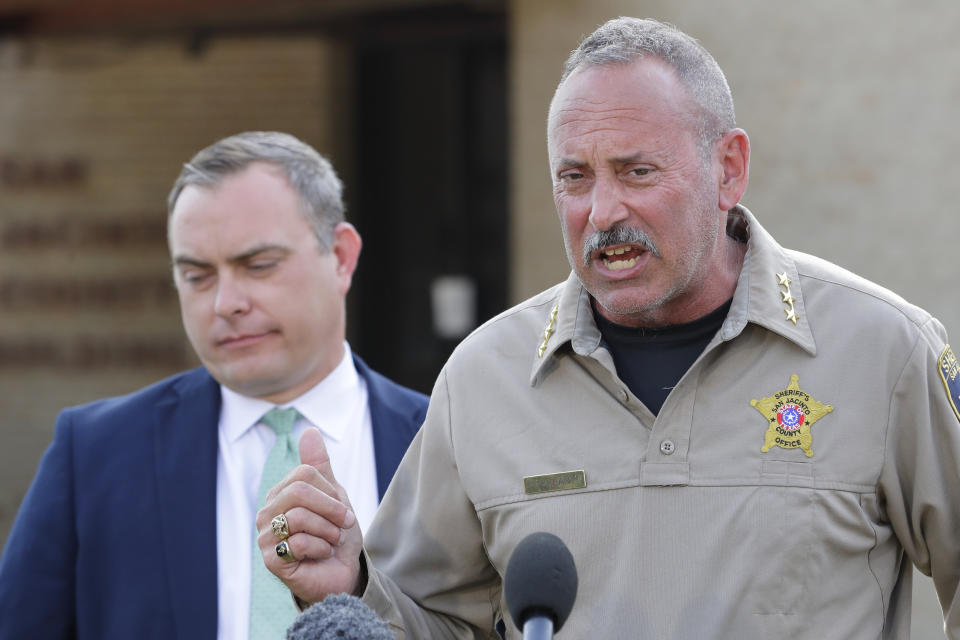 FILE - San Jacinto County Sheriff's Office Chief Deputy Tim Kean, right, introduces county district attorney Todd Dillon, left, during a news conference regarding shooting suspect Francisco Oropeza at the San Jacinto County Public Safety Building Wednesday, May 3, 2023, in Coldspring, Texas. After the April 28 mass shooting outside of Cleveland, the sheriff initially gave his “best guestimation” about the response time, said Sheriff Greg Capers’ second-in-command. Kean added that low pay has left the office short of deputies to patrol the county, where 27,000 people live scattered along dirt roads through thick forest. (AP Photo/Michael Wyke, File)