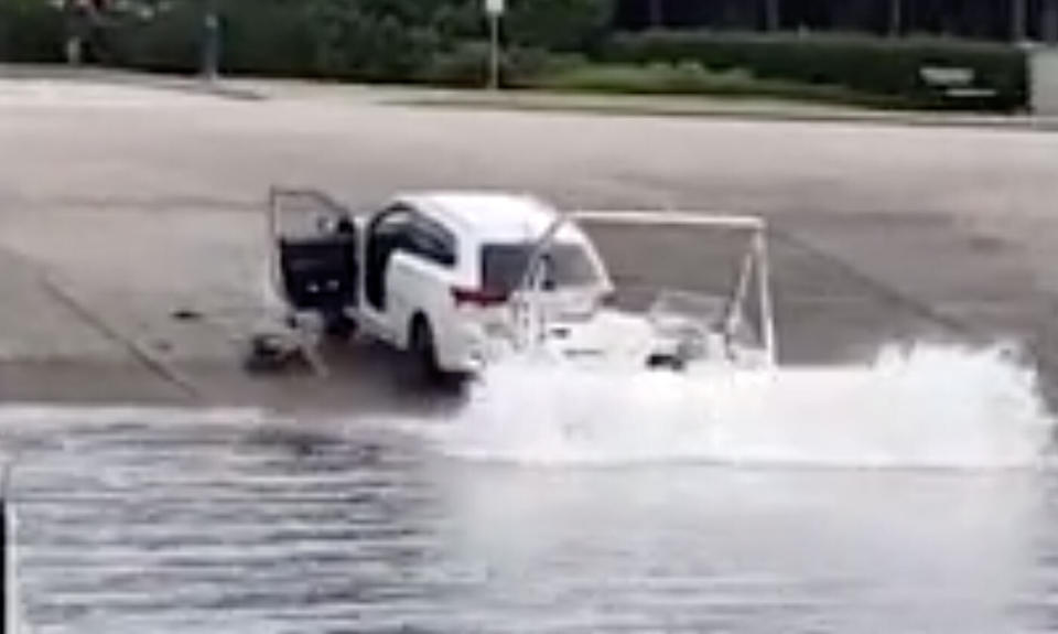 The car with the boat attached hit the water in Vancouver after a handbrake fail.