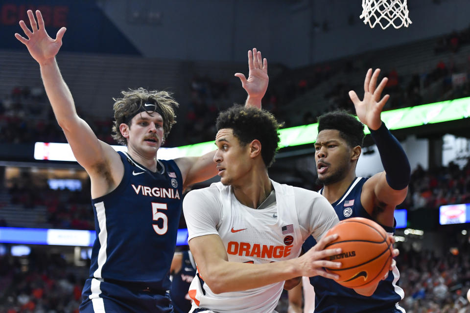 Syracuse center Jesse Edwards, center, is defended by Virginia forwards Ben Vander Plas, left, and Jayden Gardner during the first half of an NCAA college basketball game in Syracuse, N.Y., Monday, Jan. 30, 2023. (AP Photo/Adrian Kraus)