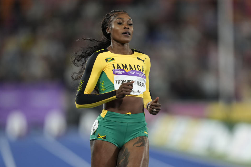 Jamaica's Elaine Thompson-Herah crosses the line to win gold in the women's 100m final during the athletics in the Alexander Stadium at the Commonwealth Games in Birmingham, England, Wednesday, Aug. 3, 2022. (AP Photo/Manish Swarup)