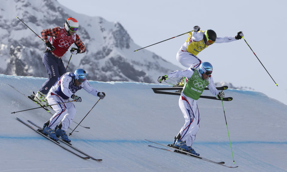 Jean Frederic Chapuis, front right, Arnaud Bovolenta, front left, Jonathan Midol, all of France, background right, and Brady Leman of Canada, background left, compete in the men's ski cross final at the Rosa Khutor Extreme Park, at the 2014 Winter Olympics, Thursday, Feb. 20, 2014, in Krasnaya Polyana, Russia. Chapuis won ahead of Bovolenta and Midol. (AP Photo/Gero Breloer)