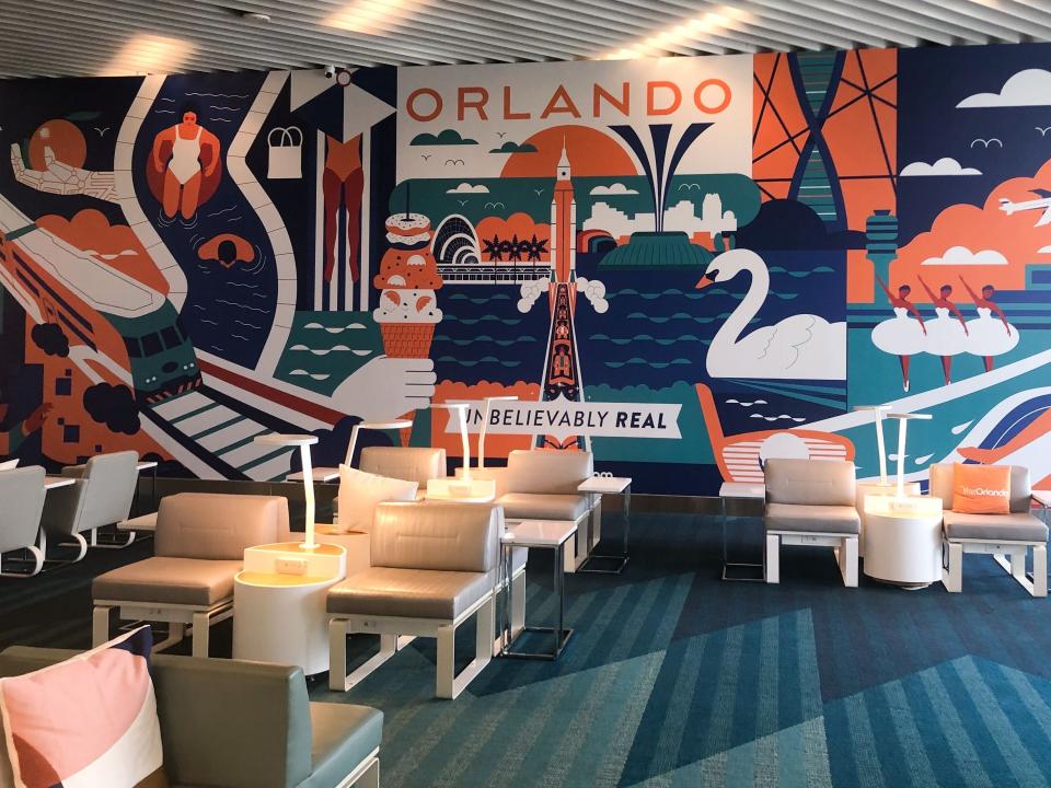 A brightly colored Orlando mural in a clean lounge area with chairs, lamps, and small tables. 