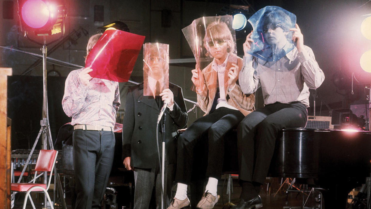  A photograph of the Beatles with coloured films held over their faces. 