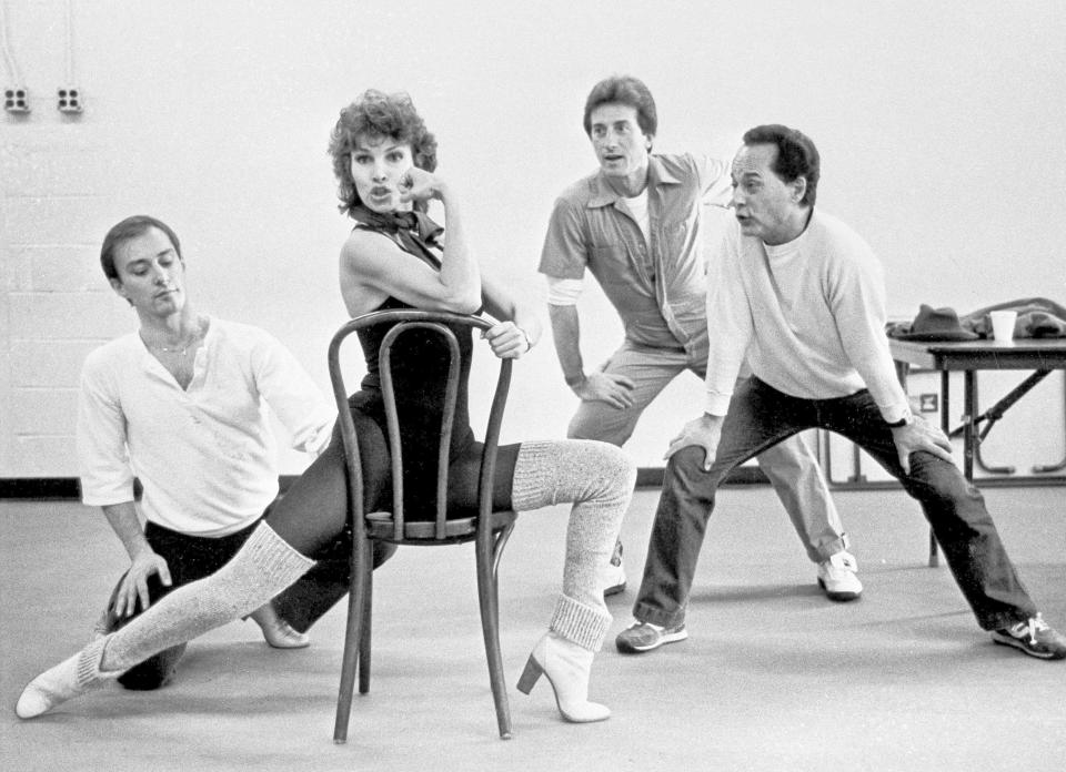 FILE - Raquel Welch appears during a rehearsal for the Broadway show "Woman of the Year," with, from left, Ed Nolfi, Sterling Clark and Paul Bogave in New York, on Nov. 12, 1981. Welch, whose emergence from the sea in a skimpy, furry bikini in the film “One Million Years B.C.” would propel her to international sex symbol status throughout the 1960s and ’70s, has died at 82. Welch died early Wednesday, Feb. 15, 2023, according to her agent, Stephen LaManna. (AP Photo/Angel Franco, File)