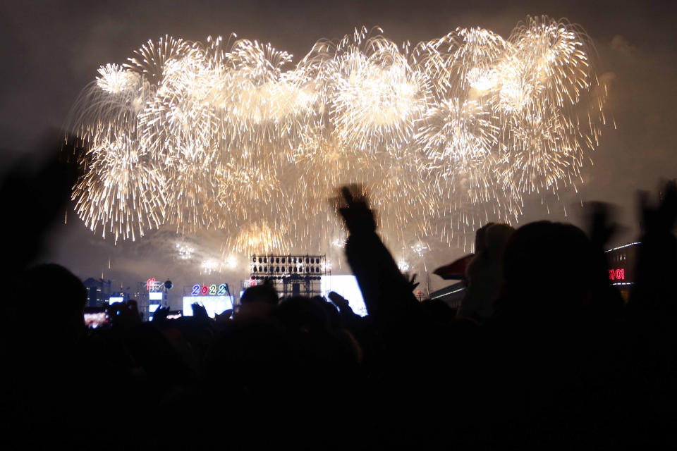 Citizens watch the fireworks celebrating the New Year on Kim Il Sung Square in Pyongyang, North Korea, Saturday, Jan. 1, 2022. (AP Photo/Jon Chol Jin)
