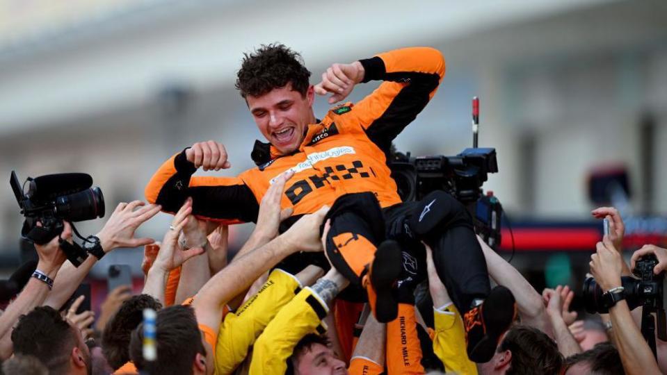 Lando Norris 'crowd-surfs' in celebration with McLaren mechanics after winning the Miami Grand Prix