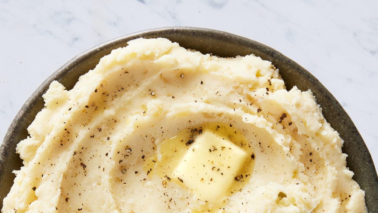 slow cooker mashed potatoes with a pat of butter, salt, and pepper