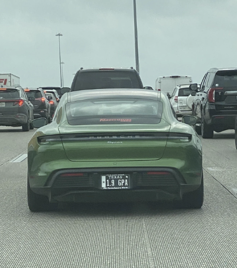 Rear view of a sports car with the license plate "1.9 GPA" in traffic