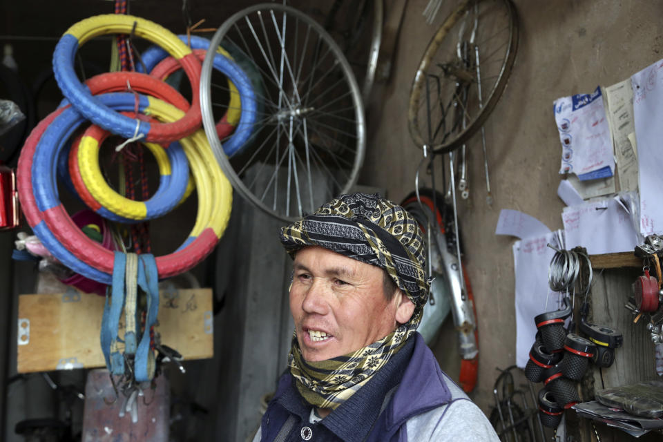 In This Wednesday, Feb. 20, 2019 photo, Mohammad Bakhsh, an ethnic Hazara bicycle repairman speaks during an interview with The Associated Press in Herat, Afghanistan. Iran paid, trained and armed thousands of Afghan Shiites to fight in Syria to defend its ally, President Bashar Assad. Most were impoverished members of the minority Hazara community unable to find jobs. Returning home as Syria’s war winds down, they face suspicion and fear. "We don't like that they go but at least in Syria they earn money," he said. (AP Photo/Rahmat Gul)