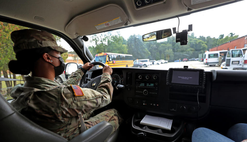 September 15: National Guard members in Reading, Massachusetts, drive school buses amid school staffing shortages due to COVID-19. (David L. Ryan / Getty Images)