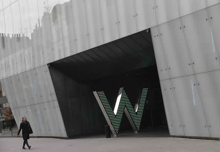 A woman walks past the 'W London' hotel, owned by Starwood Hotels, in Leicester Square in central London in this March 4, 2014 file photo. REUTERS/Toby Melville/Files