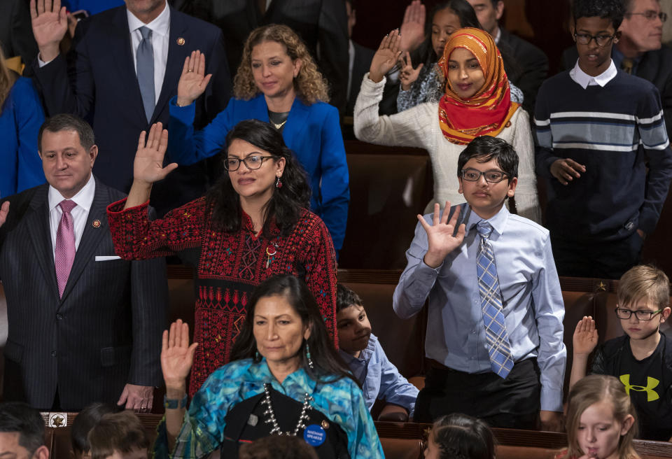 FILE - In this Jan. 3, 2019 file photo, Rep. Rashida Tlaib, D-Mich., center left, wears a Palestinian thobe as Democratic members of the House of Representatives take their oath on the opening day of the 116th Congress, at the Capitol in Washington. Tlaib proudly wore her thobe to her historic swearing-in as the first Palestinian American member of Congress, inspiring women around the world to tweet photos of themselves in their ancestral robes. (AP Photo/J. Scott Applewhite, File)