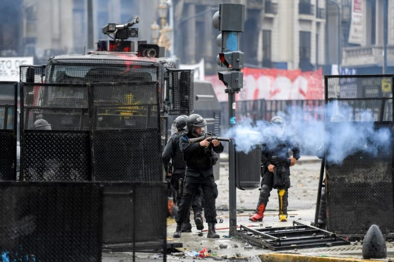 Riot police in Buenos Aires fire tear gas at protesters outside Argentina's Congress as lawmakers prepared to vote on an austerity budget to fulfill the requirements of an IMF loan package