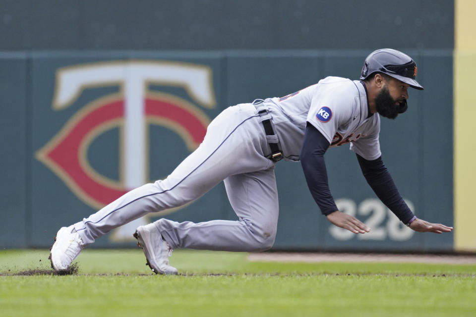 Detroit Tigers' center fielder Derek Hill dives safely back to first base on a pickoff attempt by Minnesota Twins pitcher Cody Stashak in the fourth inning of a baseball game, Thursday, April 28, 2022, in Minneapolis. (AP Photo/Jim Mone)