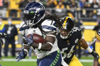 Seattle Seahawks running back Alex Collins (41) rushes past Pittsburgh Steelers outside linebacker Alex Highsmith (56) in the first half of an NFL football game, Sunday, Oct. 17, 2021, in Pittsburgh. (AP Photo/Don Wright)