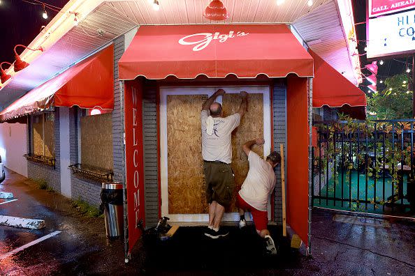 Steve Newberne (left) and Richard Latronita board up Gigi's restaurant in preparation for Hurricane Ian on September 26, 2022, in St. Petersburg, Florida.