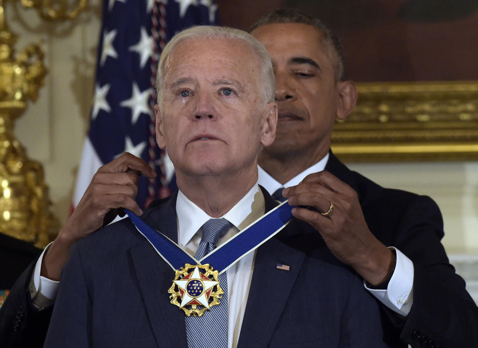 FILE - In this Jan. 12, 2017, file photo President Barack Obama presents Vice President Joe Biden with the Presidential Medal of Freedom during a ceremony in the State Dining Room of the White House in Washington. (AP Photo/Susan Walsh, File)