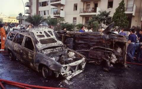 Burnt-out cars after the bomb attack which killed anti-mafia investigator Paolo Borsellino in 1992 - Credit: Tony Gentile/Reuters