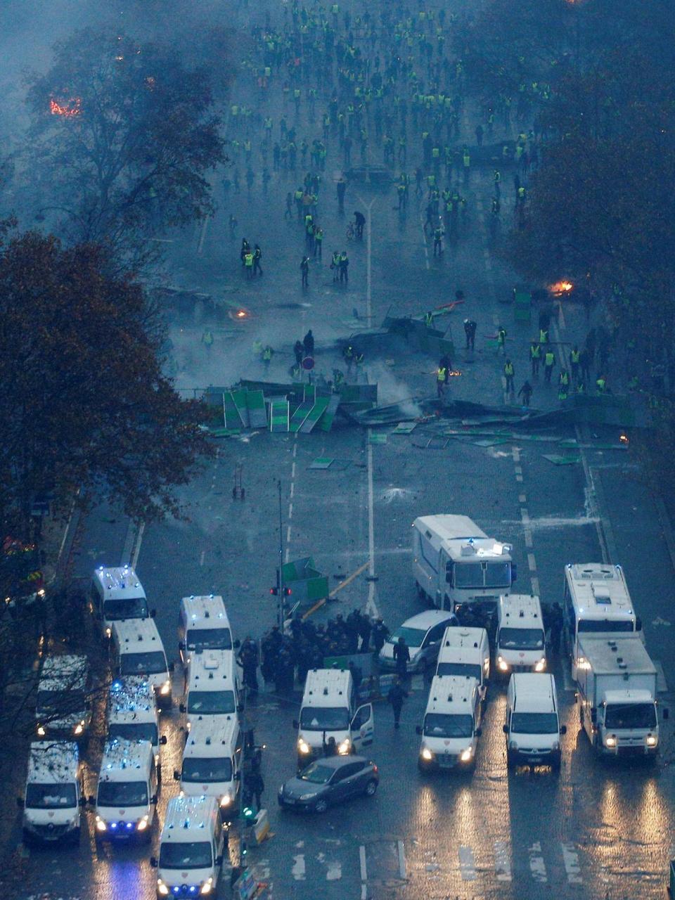 Protesters form a barricade on the Champs-Élysées (Reuters)