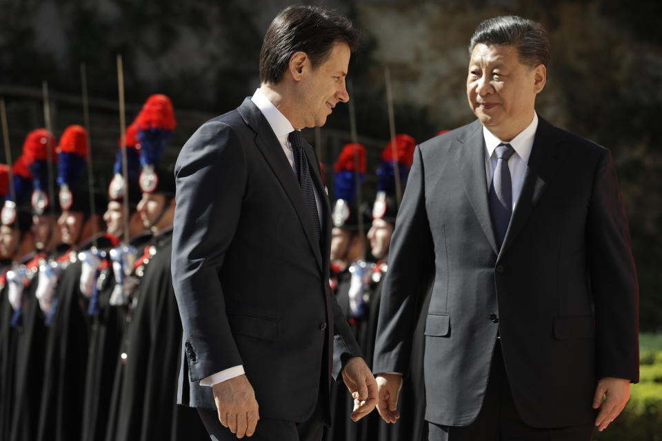 Chinese President Xi Jinping, right, and Italian Premier Giuseppe Conte walk past the honor guard during their meeting at Rome's Villa Madama, Saturday, March 23, 2019. (AP Photo/Andrew Medichini)