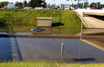 A car sits half submerged in water on Whitemud Drive following a storm that pounded south Edmonton with hail and heavy rain on July 12, 2012.