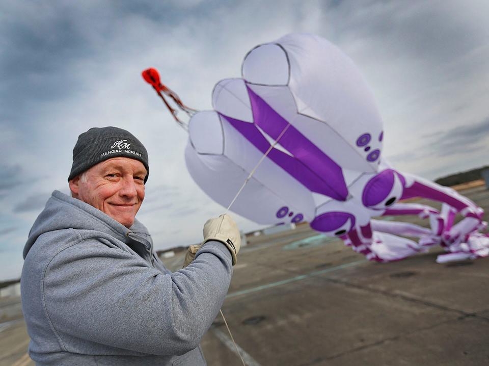 John Herr, of Rockland, flies 60-foot-long octopus kites at Union Point in South Weymouth on Thursday, Jan. 6, 2022. He uses an anchor point to hold the strings, which were once used to tie down U.S. Navy aircraft at the closed air base.