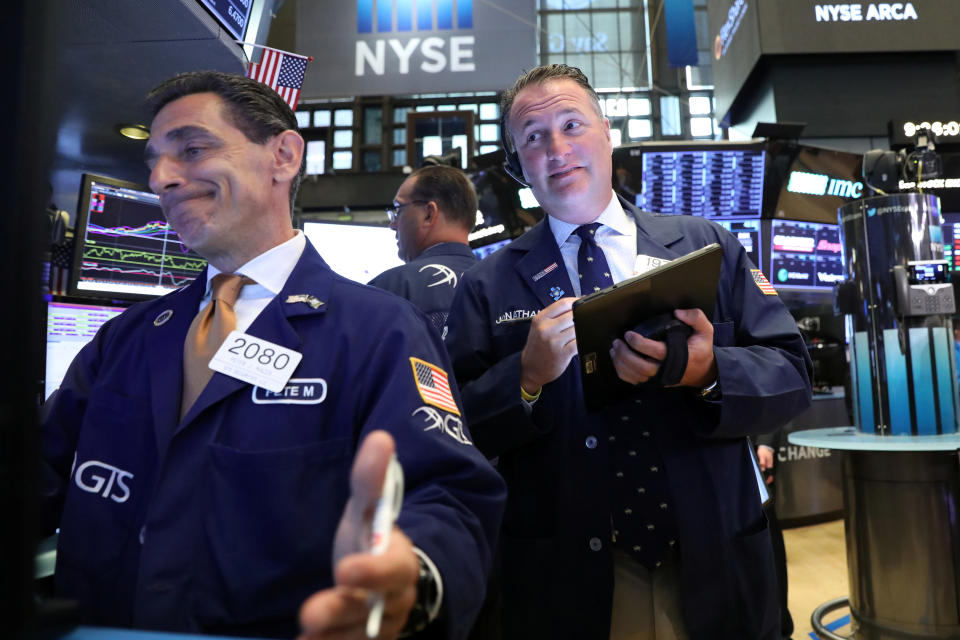 Traders work on the floor at the New York Stock Exchange (NYSE) in New York, U.S., July 16, 2019. REUTERS/Brendan McDermid