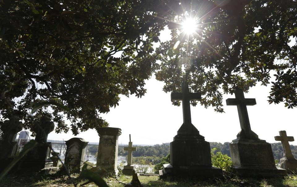 This Oct. 1, 2013 photo shows the graves of some of the 80,000 people buried in Hollywood Cemetery on the James River near downtown Richmond, Va. The cemetery opened in 1849 and has grown to more than 135 acres with more than 80,000 people buried there, including Presidents James Monroe and John Tyler, as well as Confederate President Jefferson Davis and numerous Virginia governors. (AP Photo/Steve Helber)