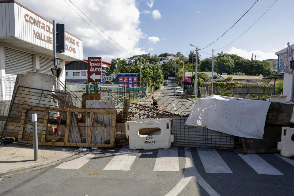 A road block in central Noumea, New Caledonia, Thursday, May 23, 2024. French President Emmanuel Macron has landed in riot-hit New Caledonia, having crossed the globe by plane from Paris in a high-profile show of support for the French Pacific archipelago wracked by deadly unrest and where indigenous people have long sought independence from France. (Ludovic Marin/Pool Photo via AP)