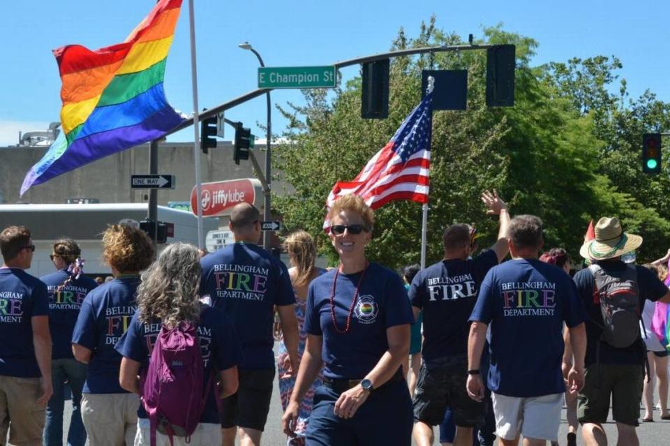 Firefighter Beth Carroll and other members of the Bellingham Fire Department participate in the Pride Parade in 2017. The Fire Department has special Pride duty shirts that use the rainbow colors of the Pride flag.