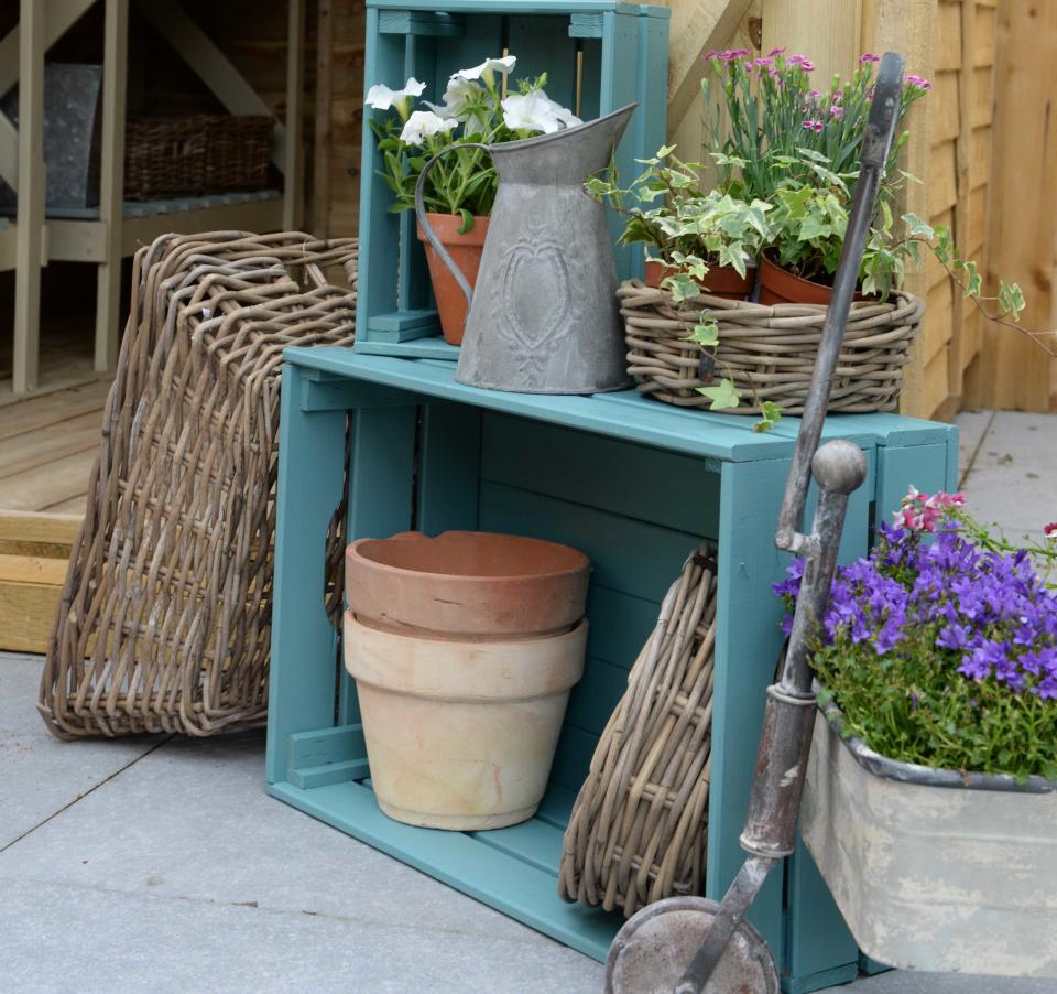 <p> Storage is super important for keeping all your garden bits and bobs in order, but can be used to show off your favorite potted plants or outdoor ornaments, too. Well, rather than splashing out on swanky new shelving, try upcycling humble wooden crates.&#xA0; </p> <p> They are super versatile &#x2013; you can position them on their side, as seen above, or connect them together vertically for your own DIY shelves (just be sure that they&apos;re secured to a wall or fence to prevent from them from toppling over). Leave them plain for a rustic look, or add a coat of the best exterior wood paint &#x2013; this soft blue makes a gorgeous accent to a garden. </p>